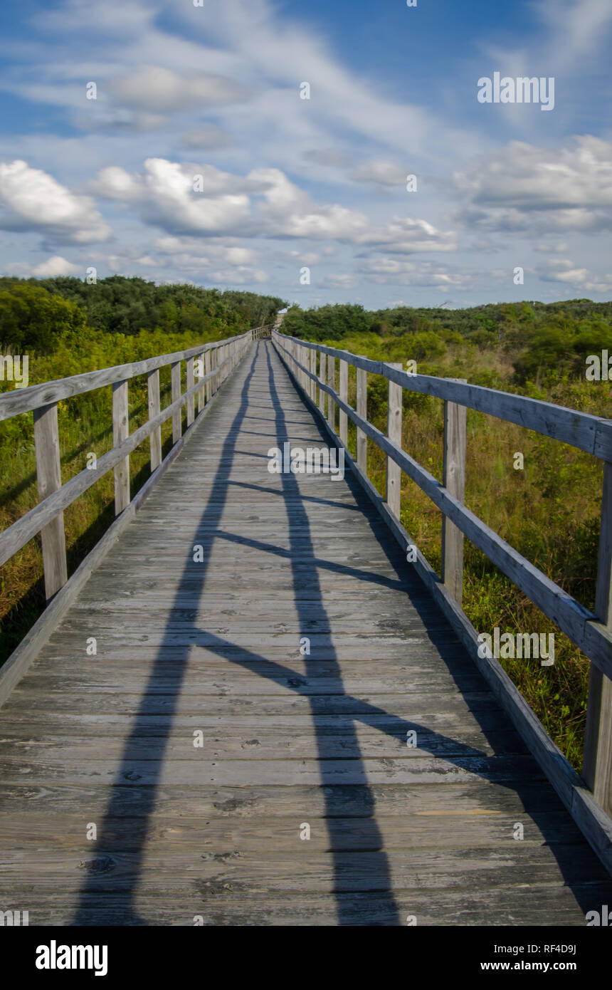 Wolken über eine Promenade durch die Dünen in Virginia Beach, Virginia fließende Stockfoto