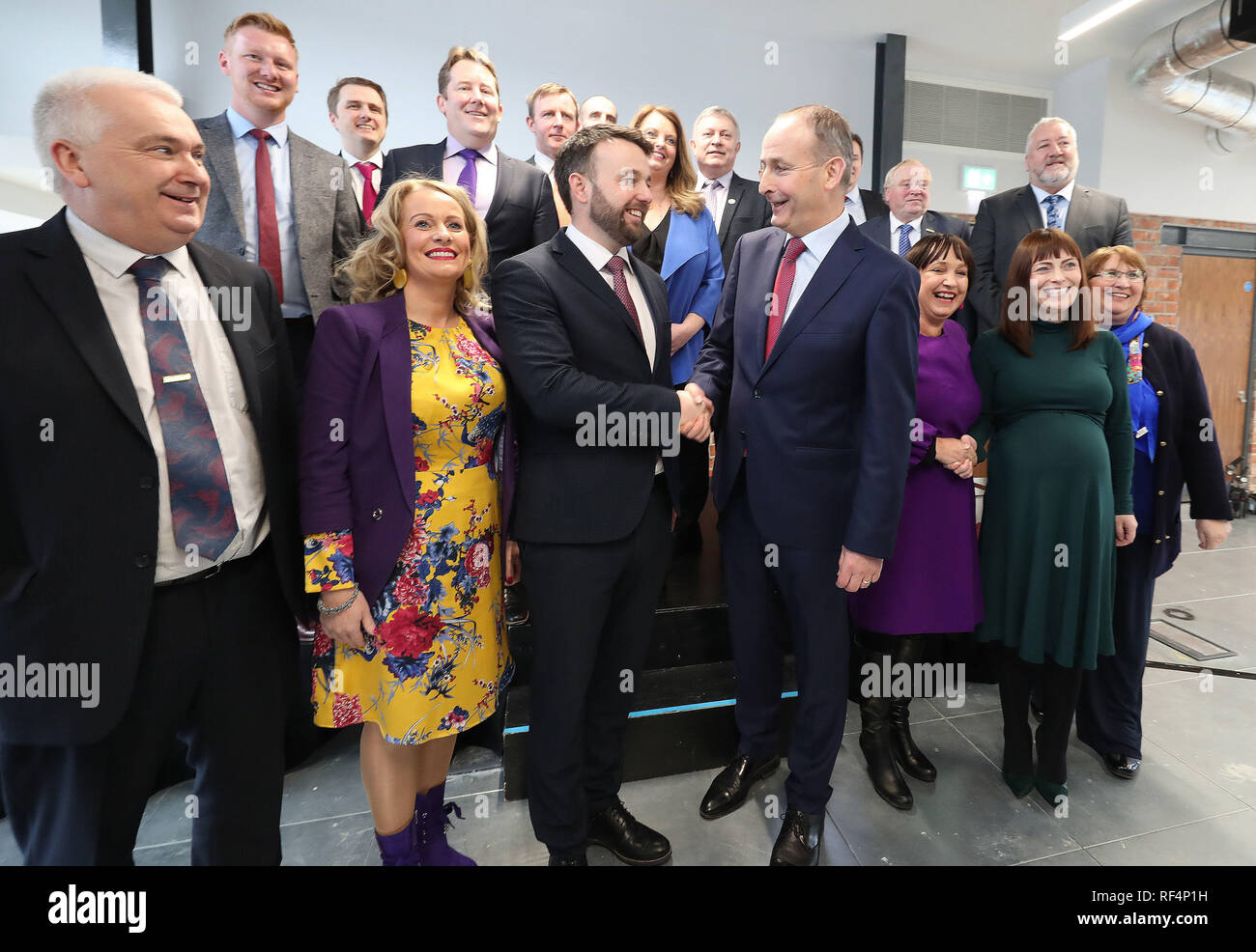 Colum Eastwood der SDLP und Micheal Martin von Fianna Fail posieren für ein Familienfoto mit Party Kollegen in Belfast als ihre politischen Parteien eine neue Partnerschaft bekannt geben. Stockfoto