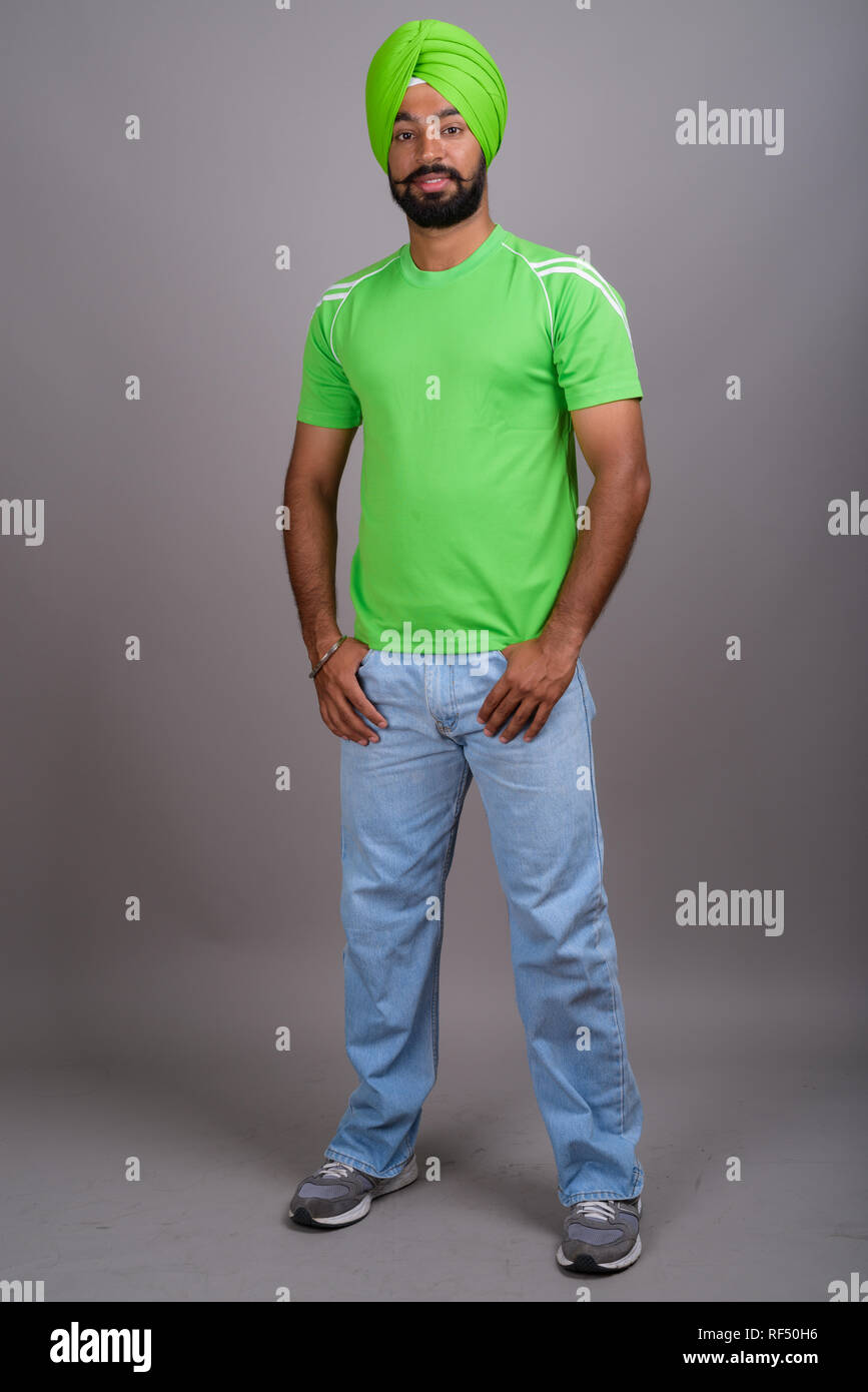 Jungen schönen Indischen Sikh Mann mit Turban und grünes T-Shirt Stockfoto