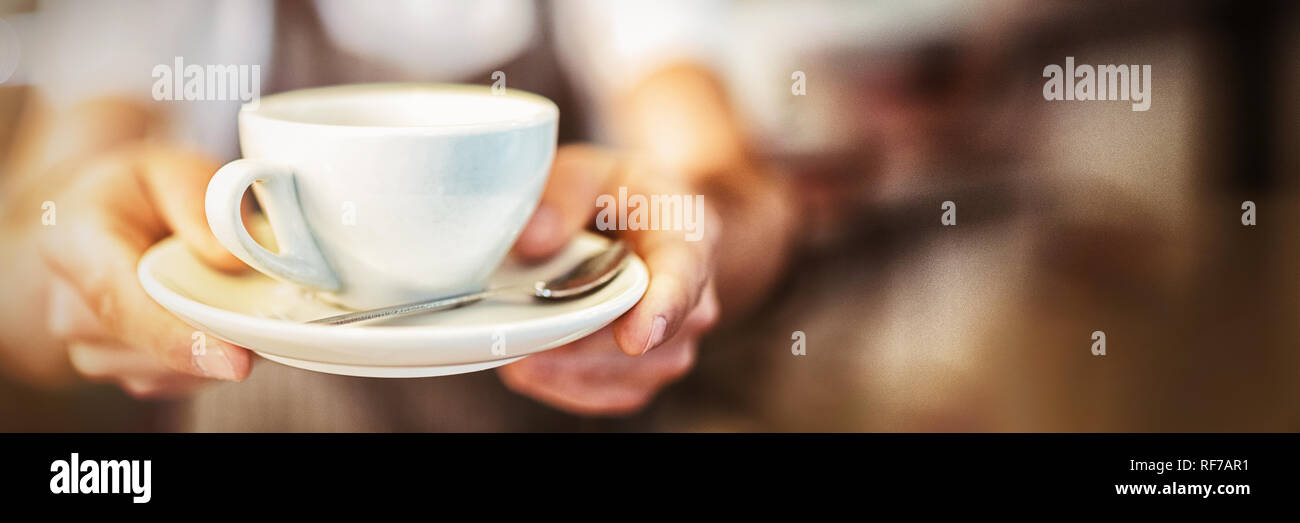 Nahaufnahme des Barista Kaffee in Cafeteria serviert Stockfoto