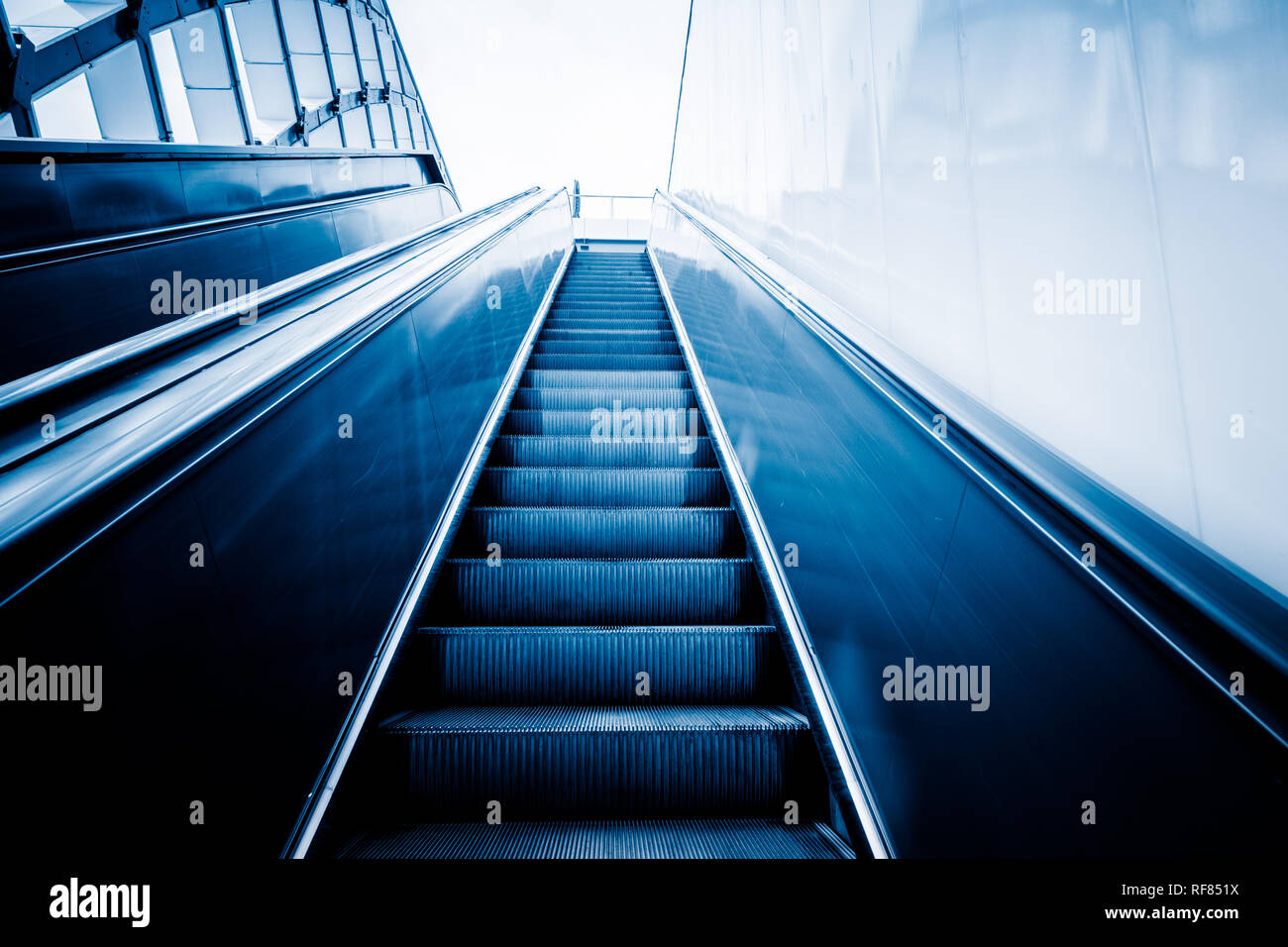 Rolltreppe der modernen Bürogebäude, blau getönten Bilder. Stockfoto