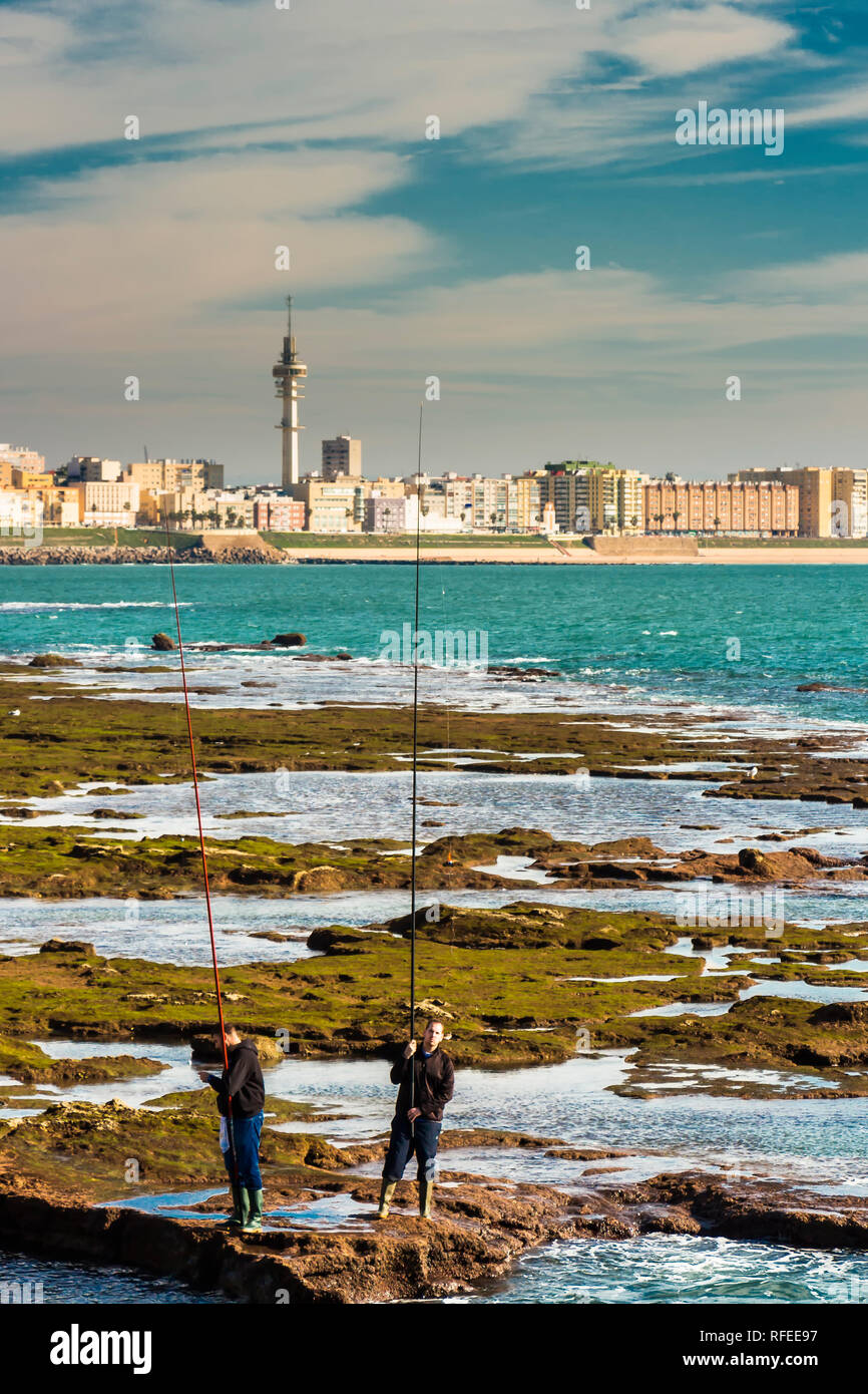 Cadiz, Spanien - Dez, 2018: Männer die Fischerei die Felsen des Paseo Fernando Chinone Stockfoto