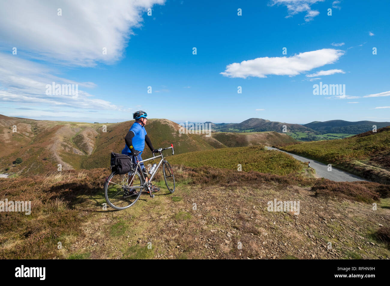 Eine männliche Radfahrer blickt auf den Shropshire Hills auf der Long Mynd in Church Stretton, Shropshire, England, Großbritannien Stockfoto