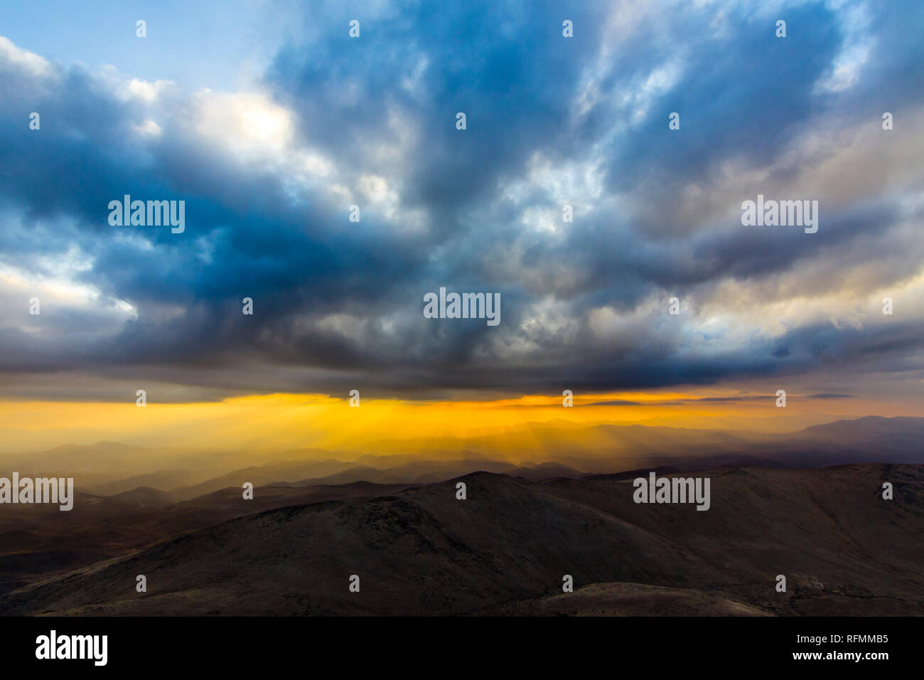 Sonnenuntergang bei 'La Silla" Sternwarte, ein Blick über den Horizont mit dem Strahl des Lichtes aus der Sonne durch die Wolken lagen über die Berge Stockfoto