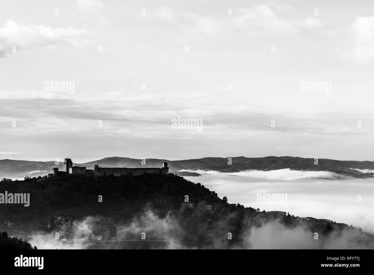 Ein Blick auf die Rocca Maggiore Schloss in Assisi (Umbrien, Italien) in der Mitte des Nebels Stockfoto