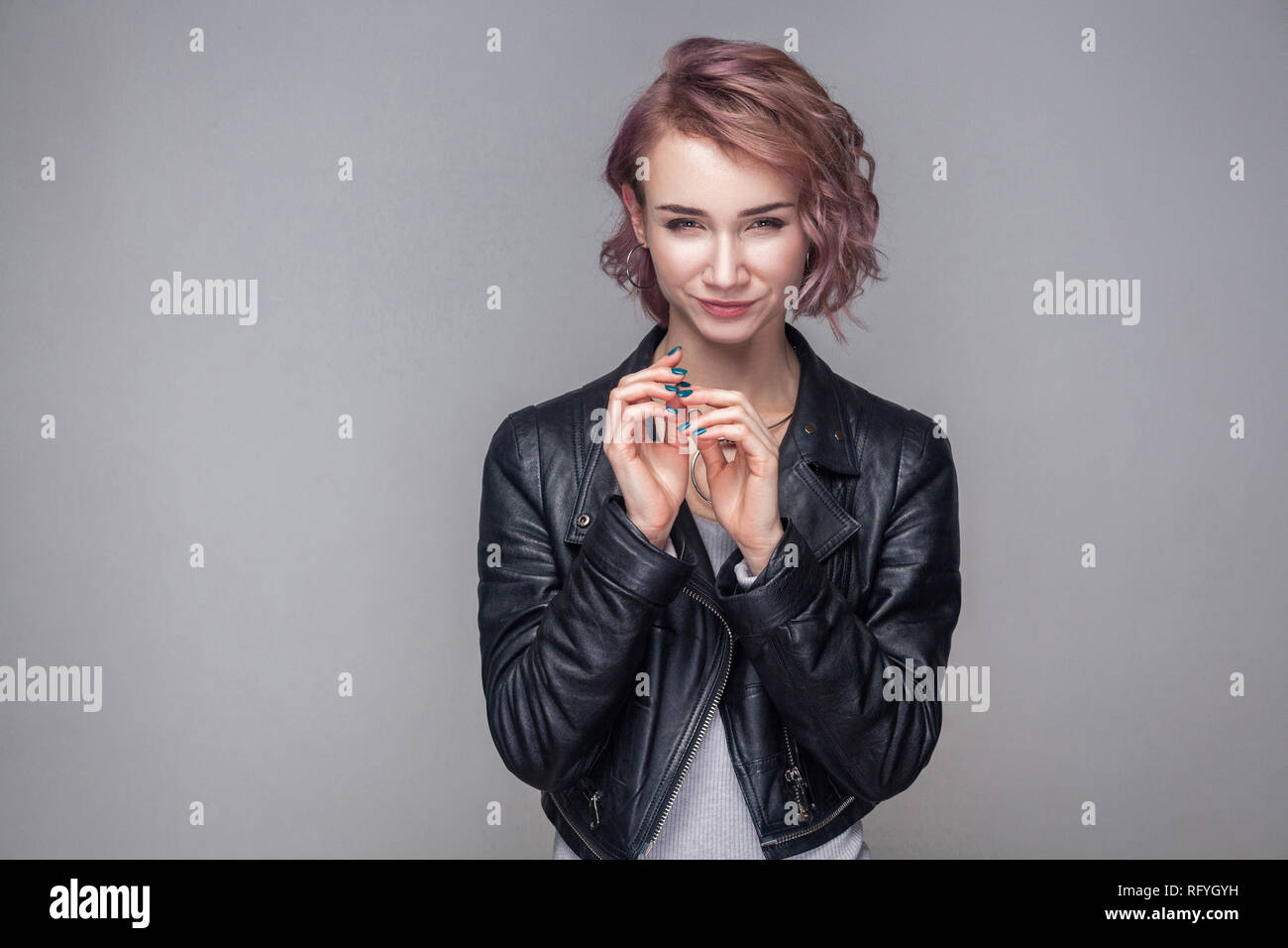 Portrait von Cheater schönen Mädchen mit kurze Frisur, Make-up im lässigen Stil schwarze Lederjacke mit gerissen Idee und Kamera. Stockfoto