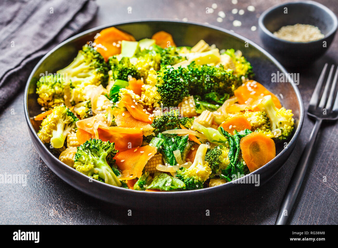 Vegan Wok braten mit Broccoli und Karotten in schwarz Schüssel rühren,  dunkle backgrond Stockfotografie - Alamy