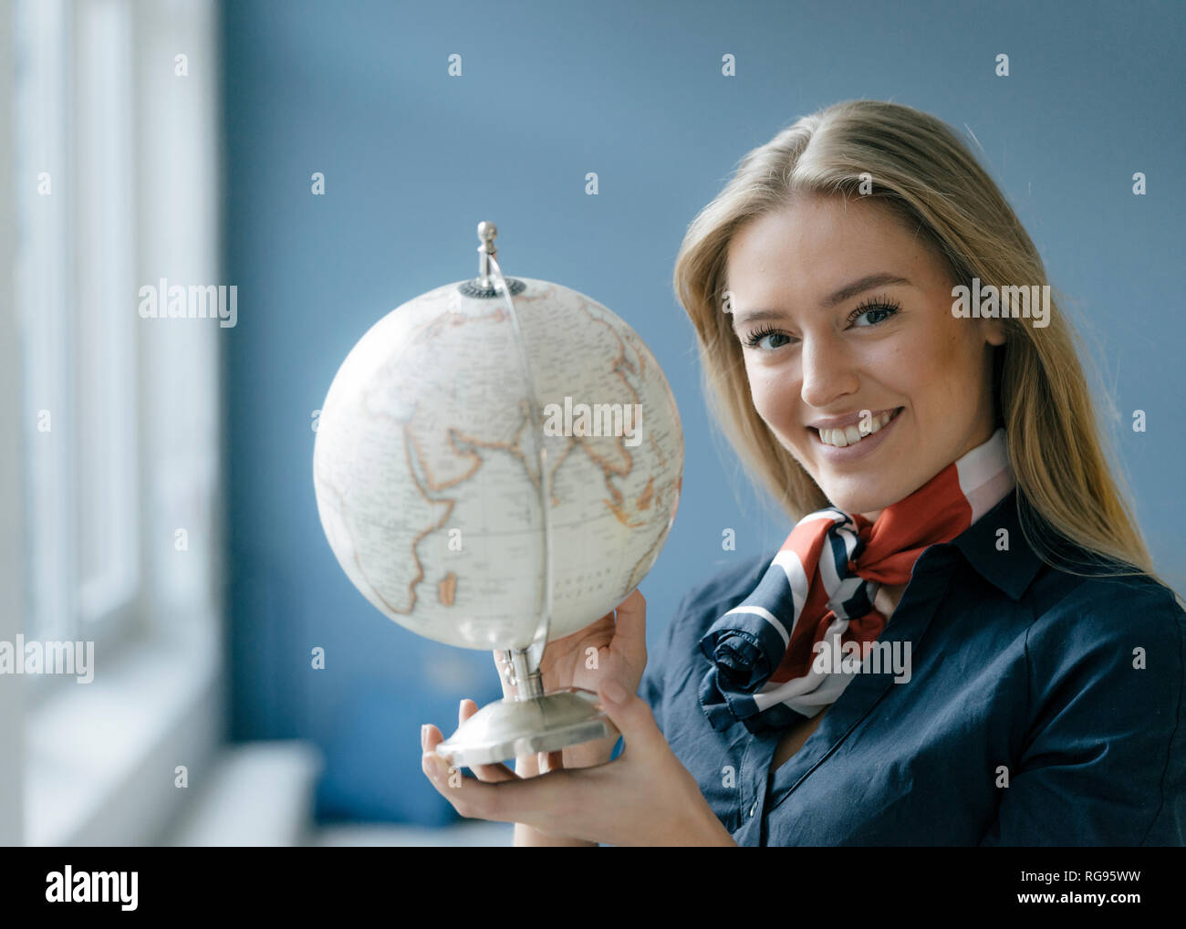 Portrait von lächelnden jungen Stewardess mit Kugel Stockfoto