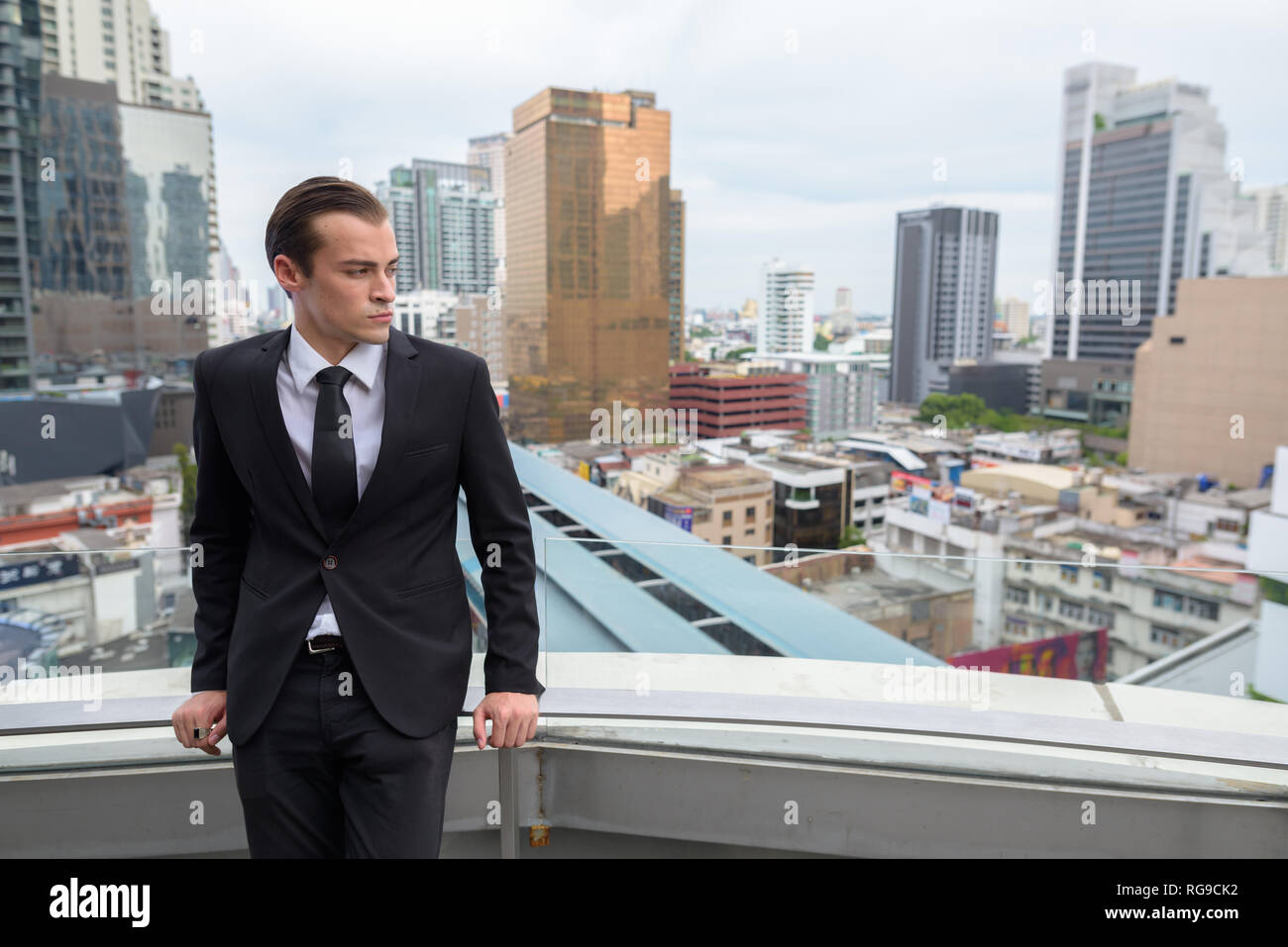 Junge Unternehmer denken draußen in der Stadt mit Aussicht auf der Dachterrasse Stockfoto