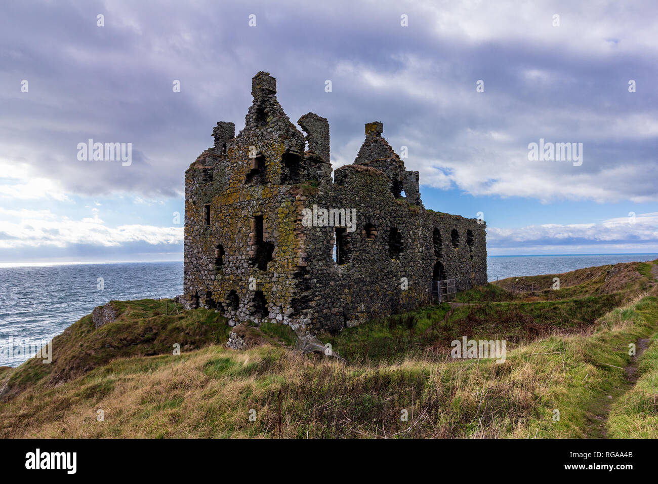 Dunskey Schloss thront auf einer Klippe mit Blick auf das Meer in der Nähe Portpatrick, Schottland, Vereinigtes Königreich unter einem dramatischen Himmel Stockfoto