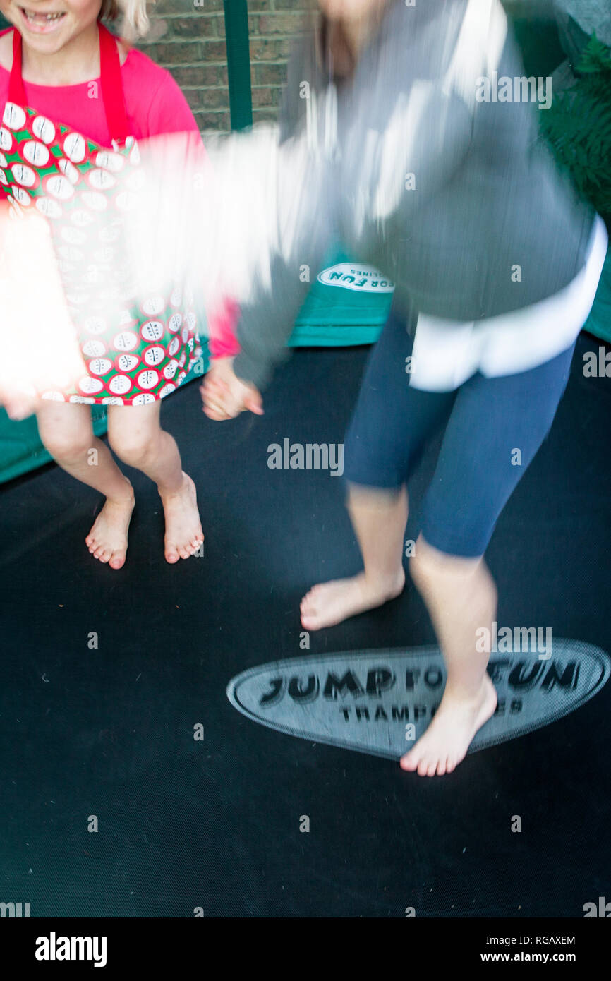 Zwei Mädchen spielen auf einem Garten trampolene, nur einen Blick auf ihre Körper Stockfoto