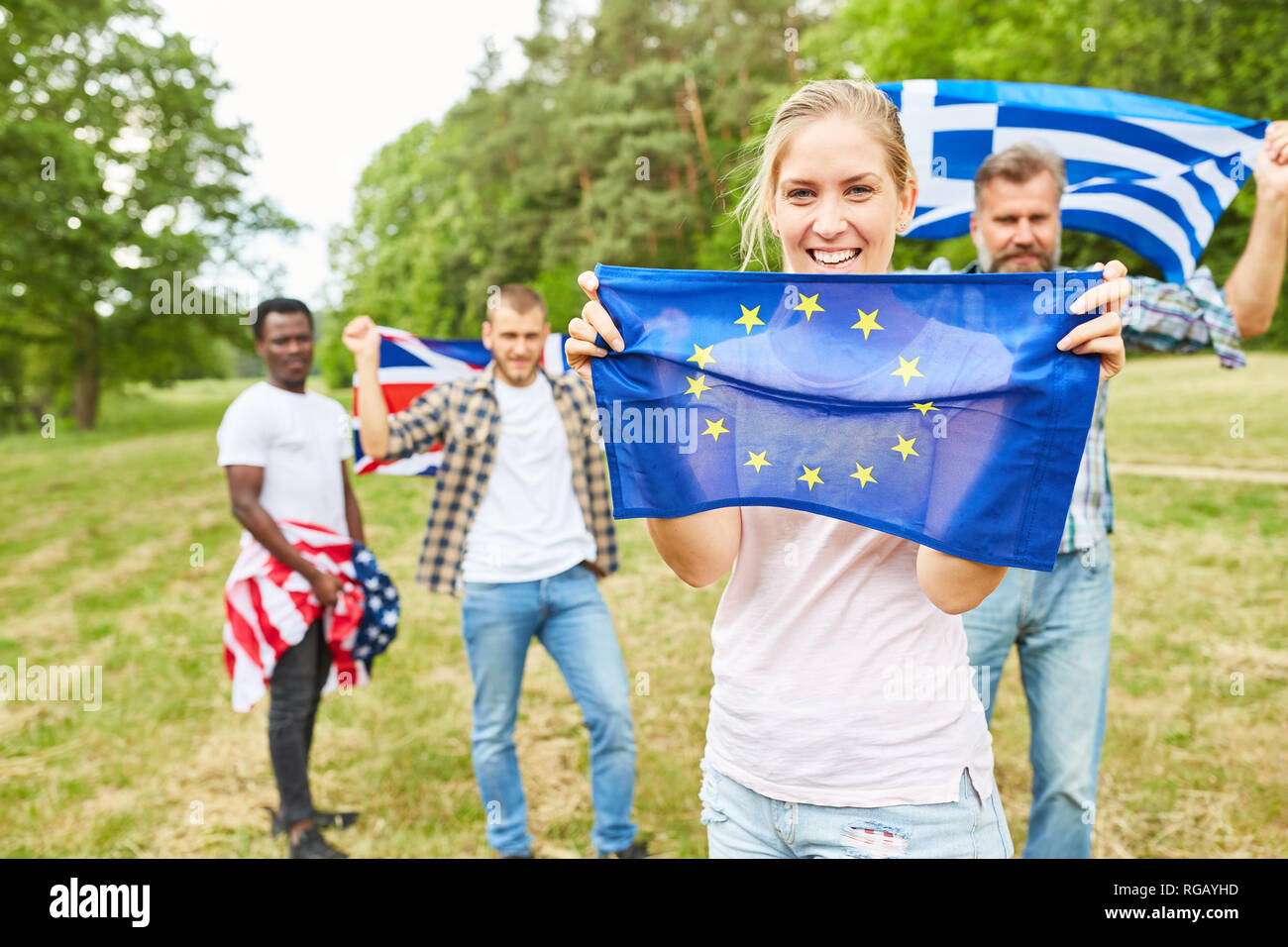 Stolz darauf, junge Frau mit EU-Flagge in den Park und Studierende mit unterschiedlichen nationalen Flaggen Stockfoto