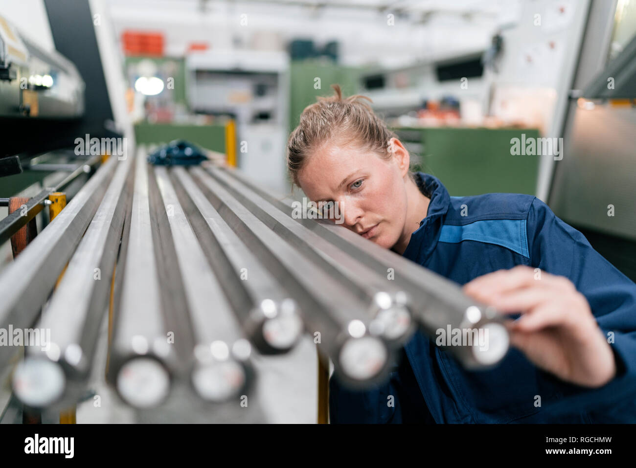 Junge Frau arbeiten als Facharbeiter in einem High-Tech-Unternehmen, Kontrolle Stahlstangen Stockfoto