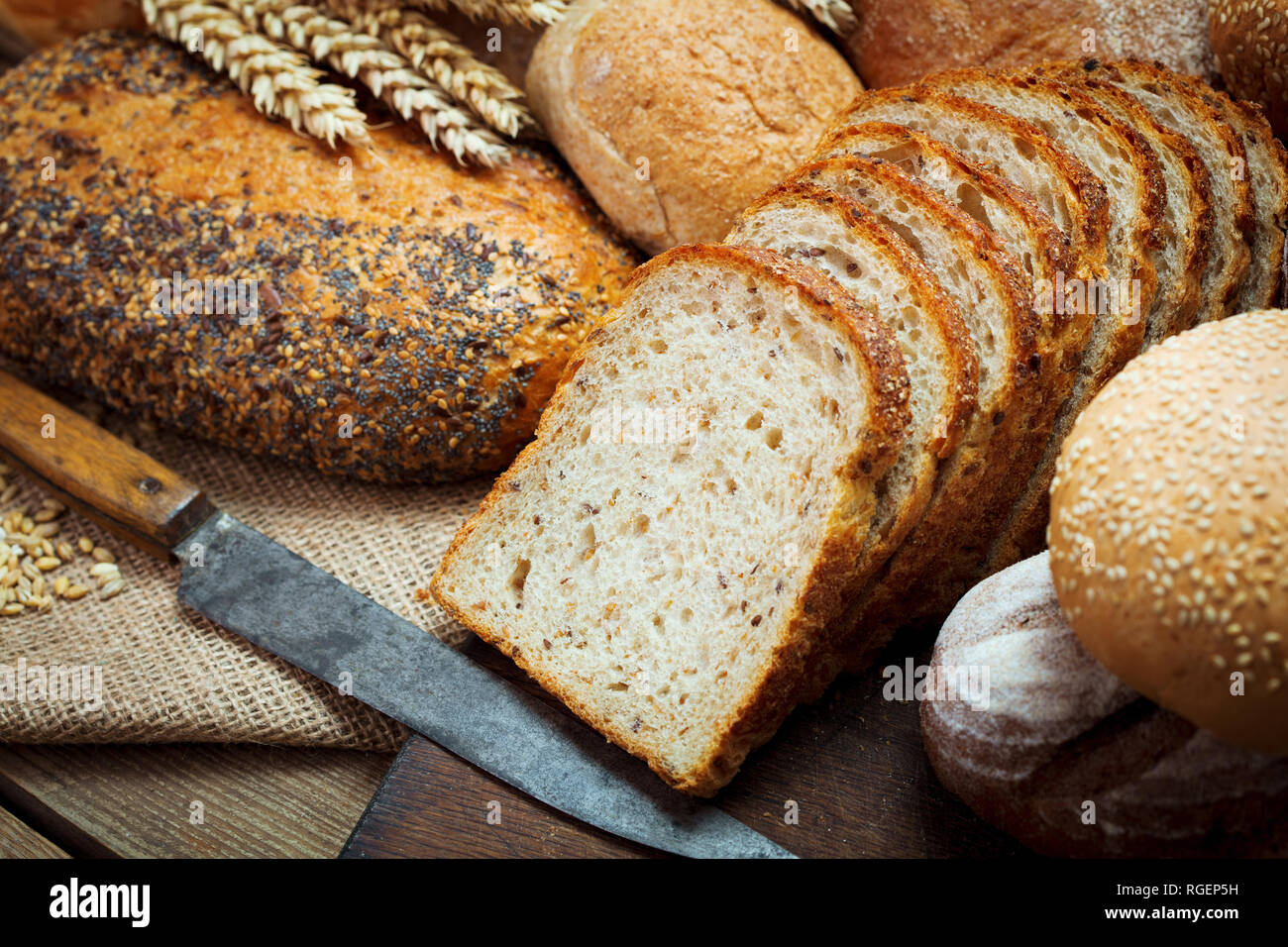 Haufen von frisch gebackenen geschnittenes Brot auf hölzernen Hintergrund Stockfoto