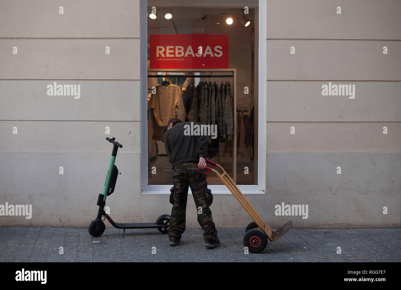 Ein Arbeitnehmer ist die Beobachtung eines freien Elektroroller auf der Straße. Der spanische General Traffic Management wird von nun an einen Führerschein für die elektroroller und eine Versicherung unter anderem Maßnahmen bedarf, entsprechend einer neuen Dekret von der spanischen Regierung. In den letzten Monaten hat mehr Unfälle mit Elektroroller passiert, und ein Tod im vergangenen Jahr. Die Regierung erwarten, wie dies der Verwendung dieser Transporte zu regulieren und die Sicherheit verbessern. Stockfoto