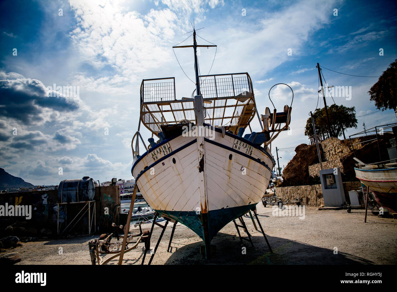 Altes Fischerboot an der Küste. Ein Schiff an Land gezogen. Hafen in der Ortschaft Hersonissos auf der Insel Kreta, Griechenland. Stockfoto