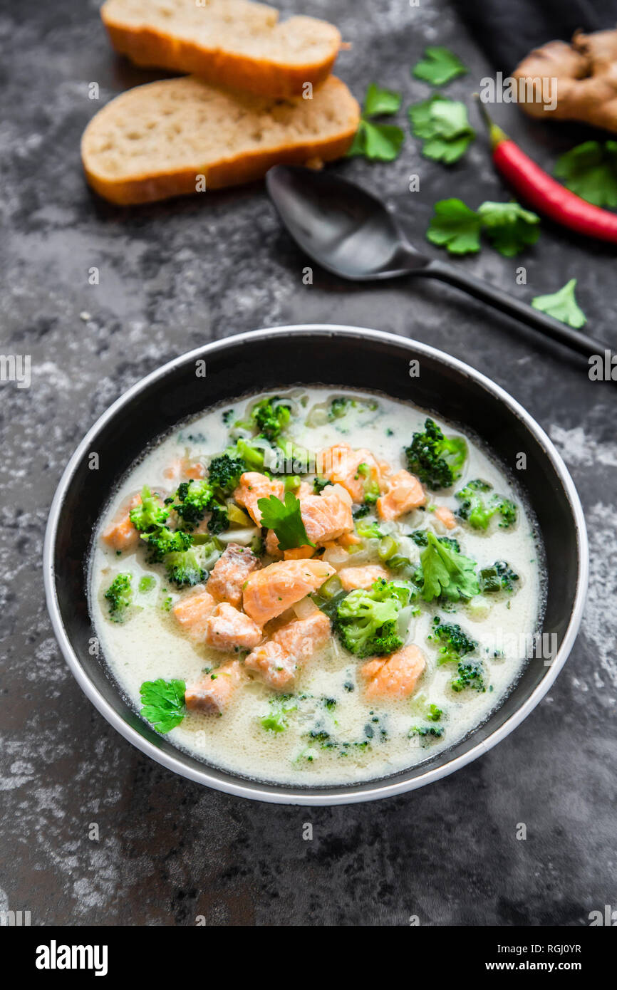Cocos lachs Suppe, mit Brokkoli, Lauch, Kokosmilch, Petersilie, Chili, Ingwer und Baguette Stockfoto