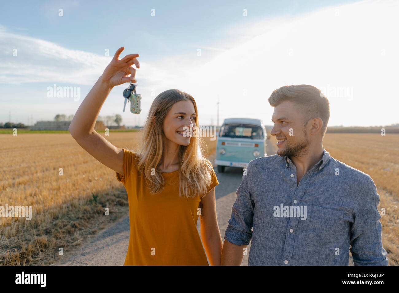 Junges Paar mit dem Schlüssel auf Feldweg im Wohnmobil in ländlichen Landschaft Stockfoto