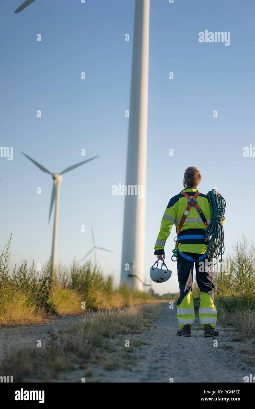 Techniker stehen auf Feld Pfad in einen Windpark mit Kletterausrüstung Stockfoto