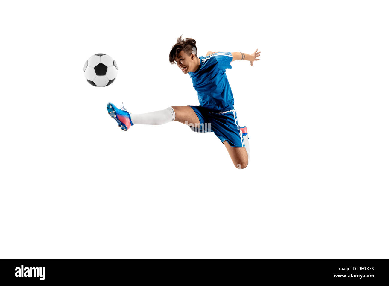 Junge mit Fußball zu tun Flying Kick, isoliert auf Weiss. Fußball-Spieler in Bewegung in Studio Hintergrund. Fit springen Junge in Action, Jump, Bewegung im Spiel. Stockfoto