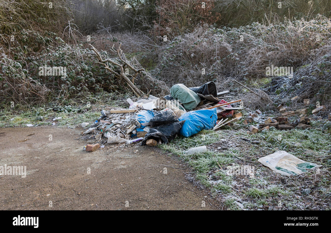 Illegale Flytipping Baumeister Müll gedumpten auf dem Parkplatz in der Nähe von Naturschutzgebiet Hertfordshire, Großbritannien Stockfoto