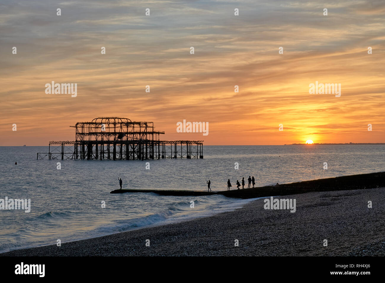 Die Ruinen von West Pier von Brighton gegen die untergehende Sonne. Stockfoto