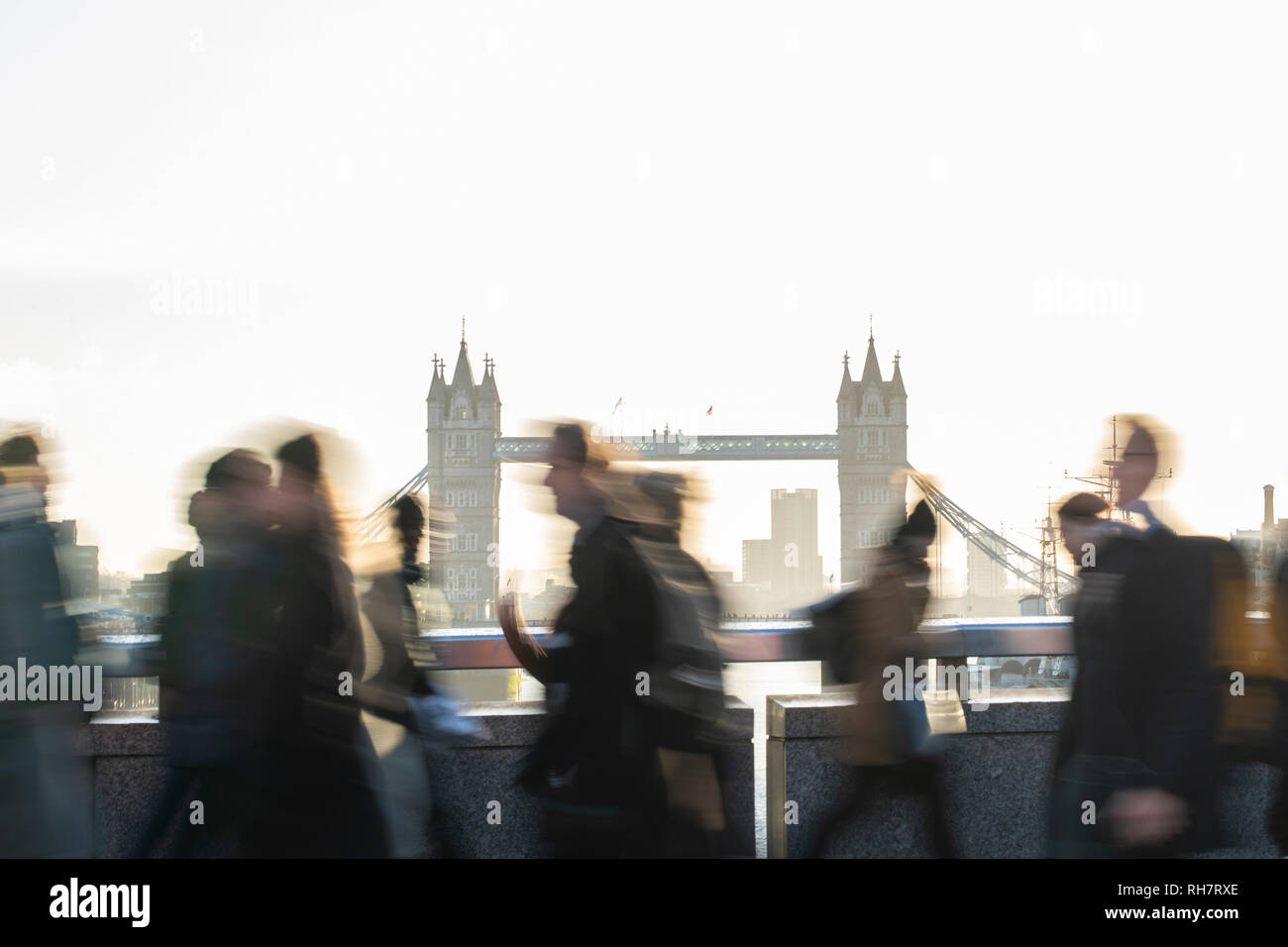 Motion Blur Schuß von Pendlern zu Fuß zur Arbeit in Großbritannien mit London Bridge Tower Bridge im Hintergrund Stockfoto