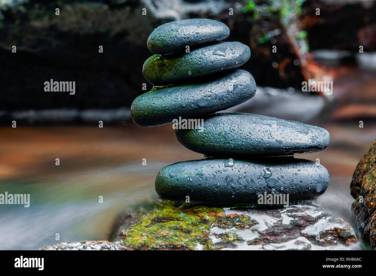 Ausgewogene Steine auf einen Wasserfall Stockfoto