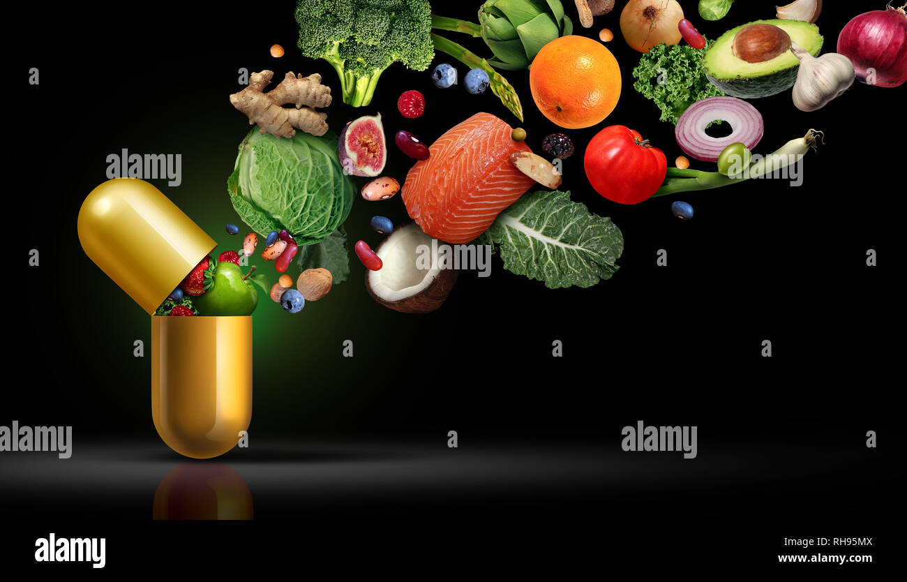 Vitamine Nahrungsergänzungsmittel Ernährung als Kapsel mit Obst Gemüse Nüsse und Bohnen in einem Nährstoff Pille als natürliche Medizin Gesundheit Behandlung. Stockfoto