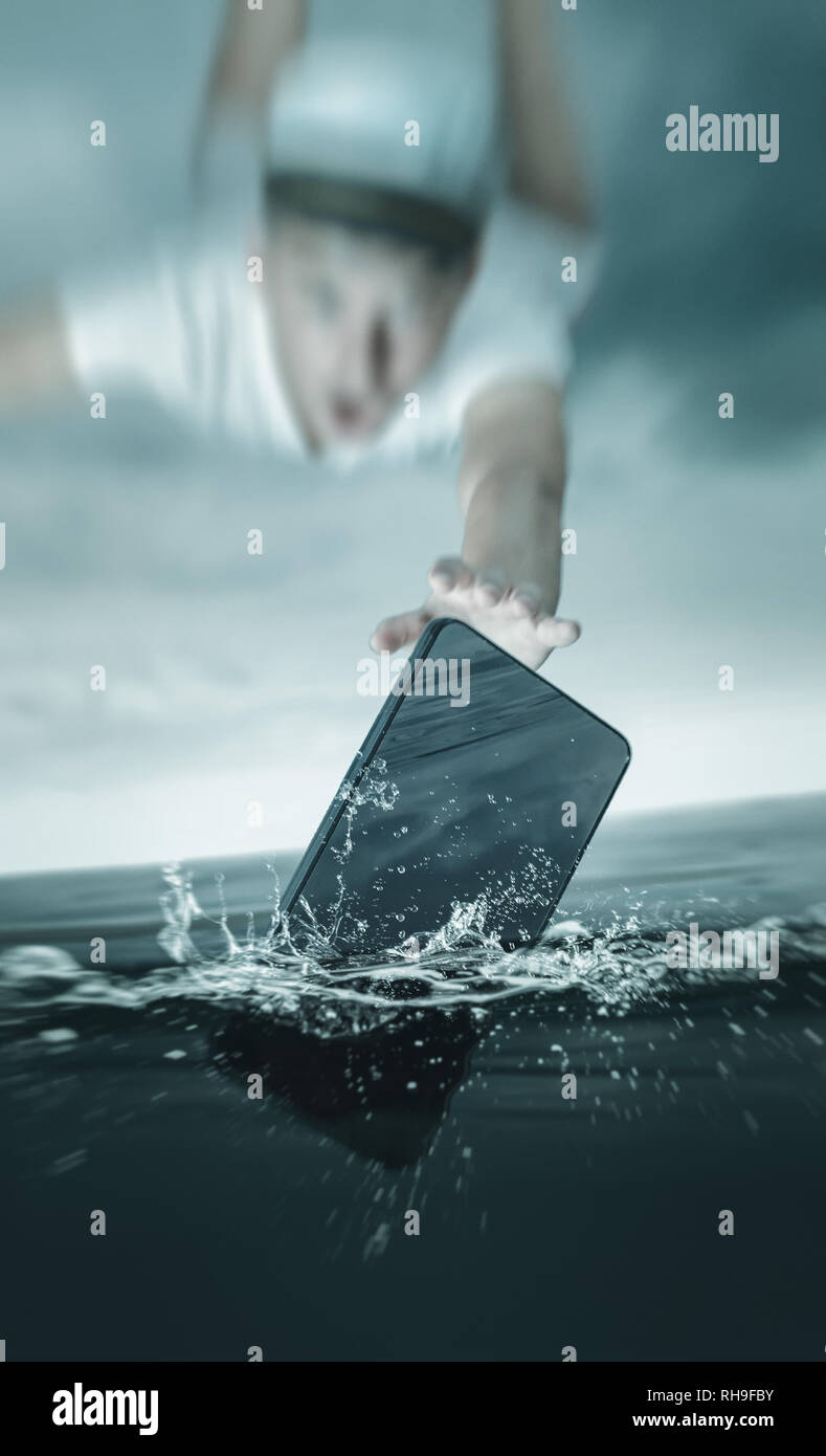 Junge Kapitän fliegen nach dem Smartphone, das ins Wasser fallen Stockfoto