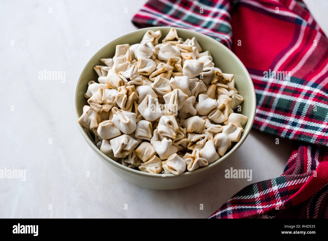 Hausgemachte knusprige Manlama Raw manti (Türkische Ravioli) in der Schüssel. Traditionelle Instant Essen. Stockfoto