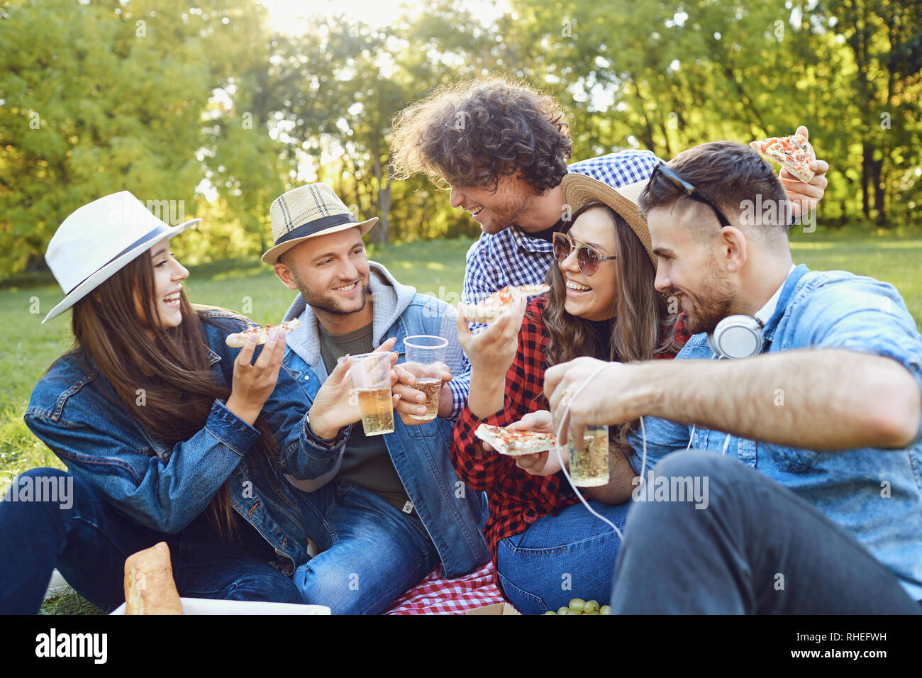 Eine Gruppe junger Menschen, die auf einem Picknick im Park. Stockfoto
