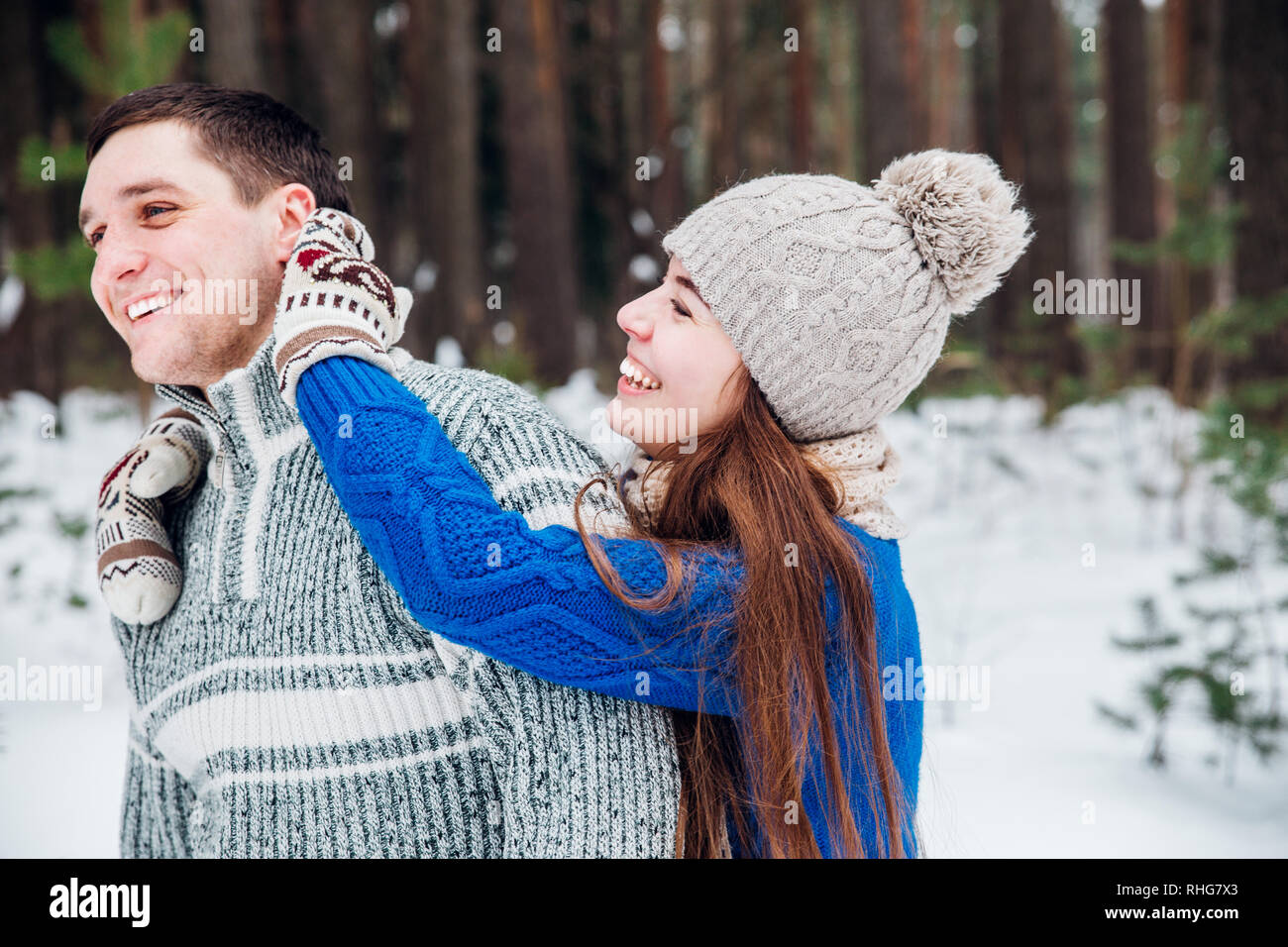 Liebevolle junges Paar, das Spaß im Winter Wald. Stockfoto