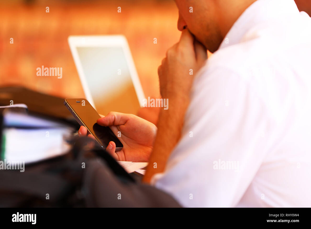 Nahaufnahme eines männlichen Schüler mit einem Handy SMS an der Schule. Ablenkungen und Schule mit sozialen Medien und der digitalen Technologie Stockfoto