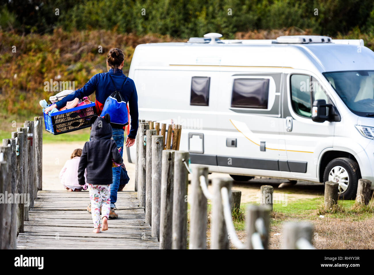 Familie wandern Van mit Box von Spielwaren für Camper. Familie ist die  Rückgabe von Spielen am Strand. Auf dem Weg zum Wohnmobil auf Holz- Weg  über Sand du Stockfotografie - Alamy