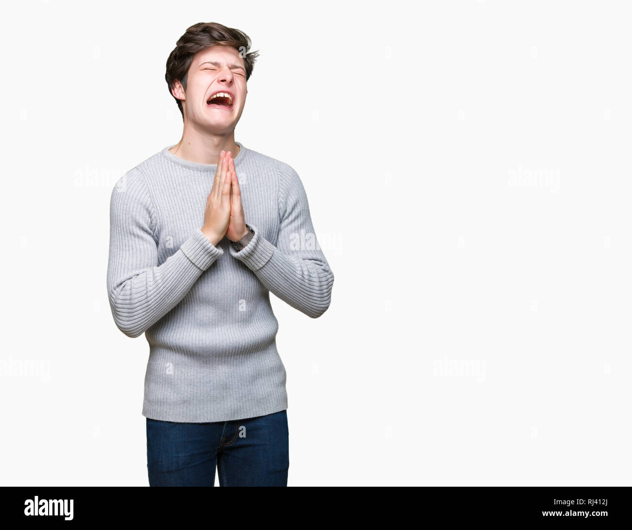 Jungen gutaussehenden Mann tragen winter Pullover über isolierte Hintergrund betteln und mit Händen gemeinsam beten mit der Hoffnung Ausdruck auf dem Gesicht sehr emotionale Stockfoto