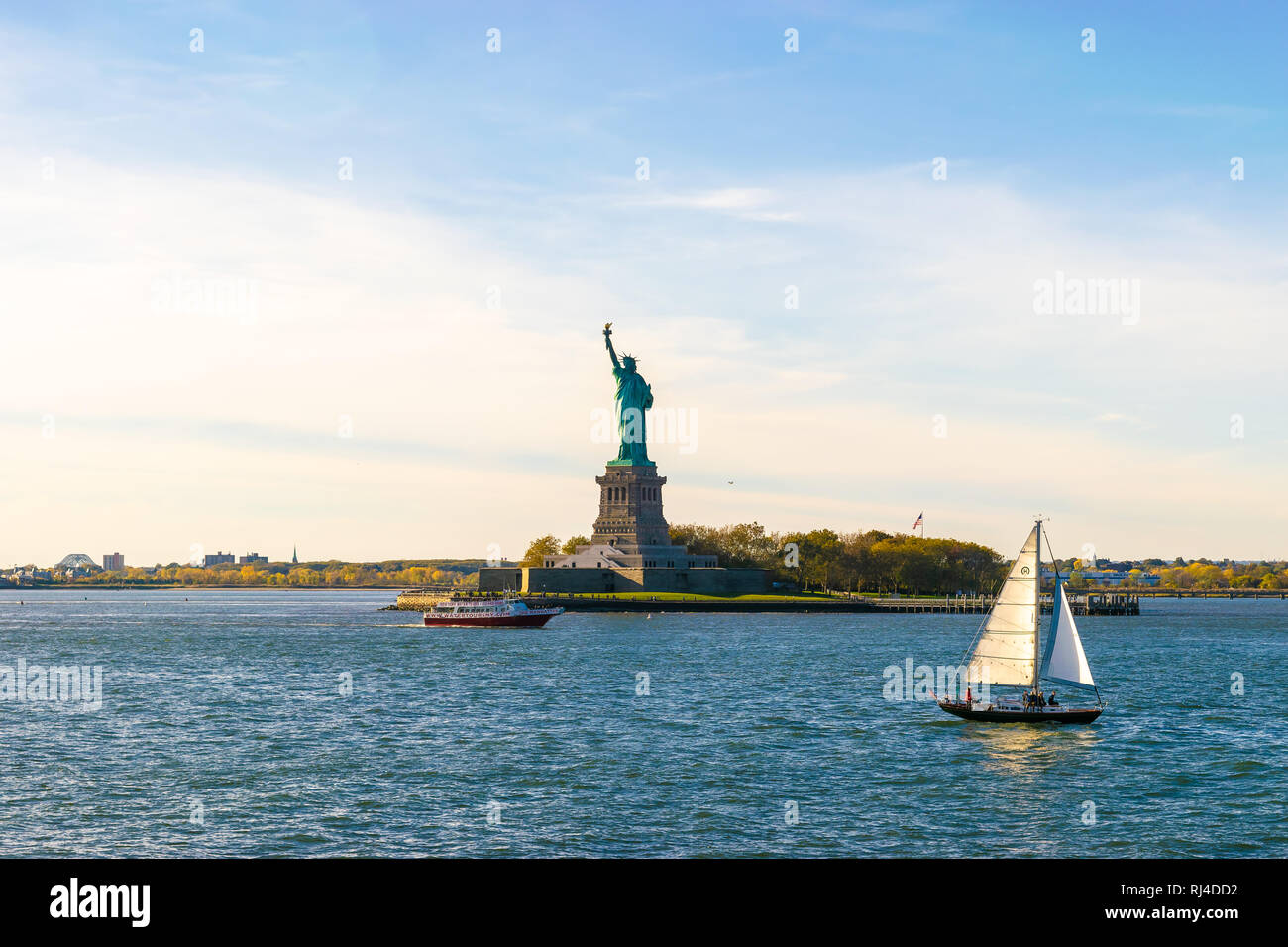 New York - 17. Oktober 2016: Boote, die von dem bekannten Symbol der Freiheit - die Freiheitsstatue in New York City. Stockfoto