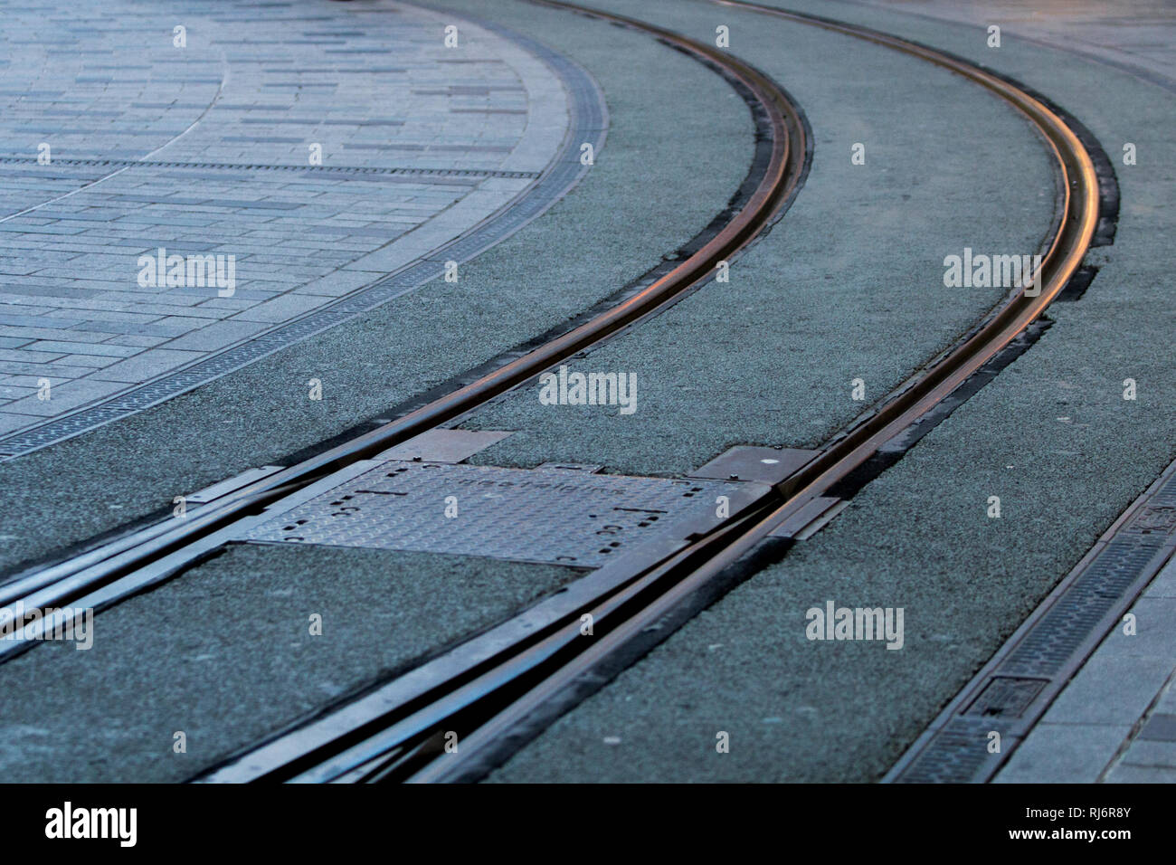 Straßenbahn Schienen auf dem Boden krümmen auf der linken Seite. Stockfoto