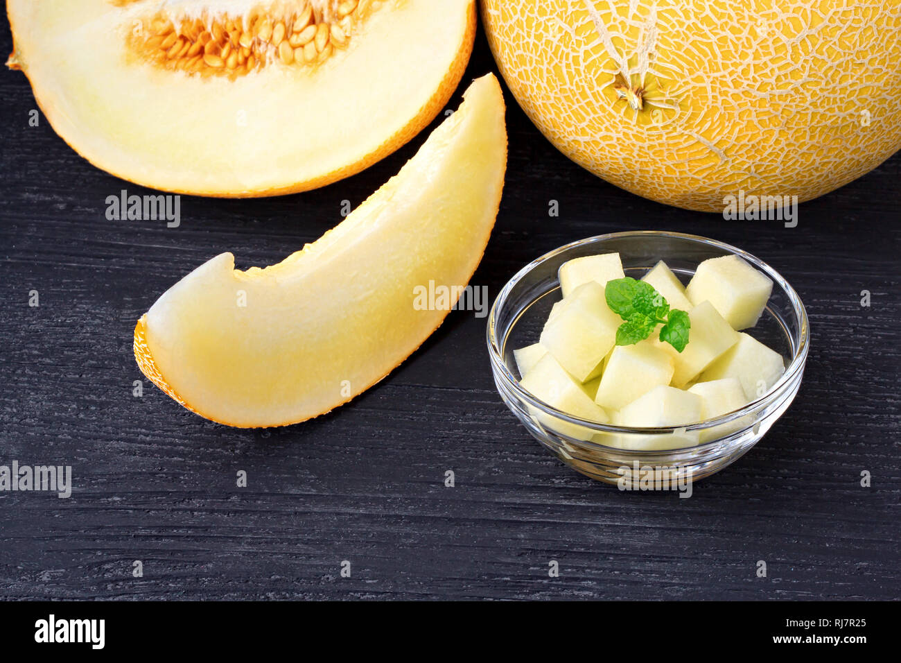 Frischen süßen Orangen Melone auf einem alten schwarzen Holztisch (selektive Fokus). Stockfoto