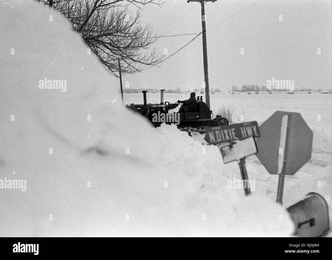 Ein Ohio National Guard Soldat verwendet Heavy Engineer Ausrüstung räumen Schnee von eine Straße entlang North Dixie Highway nördlich von Bowling Green, Ohio während der Zustand aktiv verpflichtet, Maßnahmen zur Unterstützung der "Blizzard von "78". Die Ohio National Guard spielte eine wesentliche Rolle bei der Wiederherstellung der Roßkastanie-Zustand. (Ohio Army National Guard historische Sammlungen) Stockfoto
