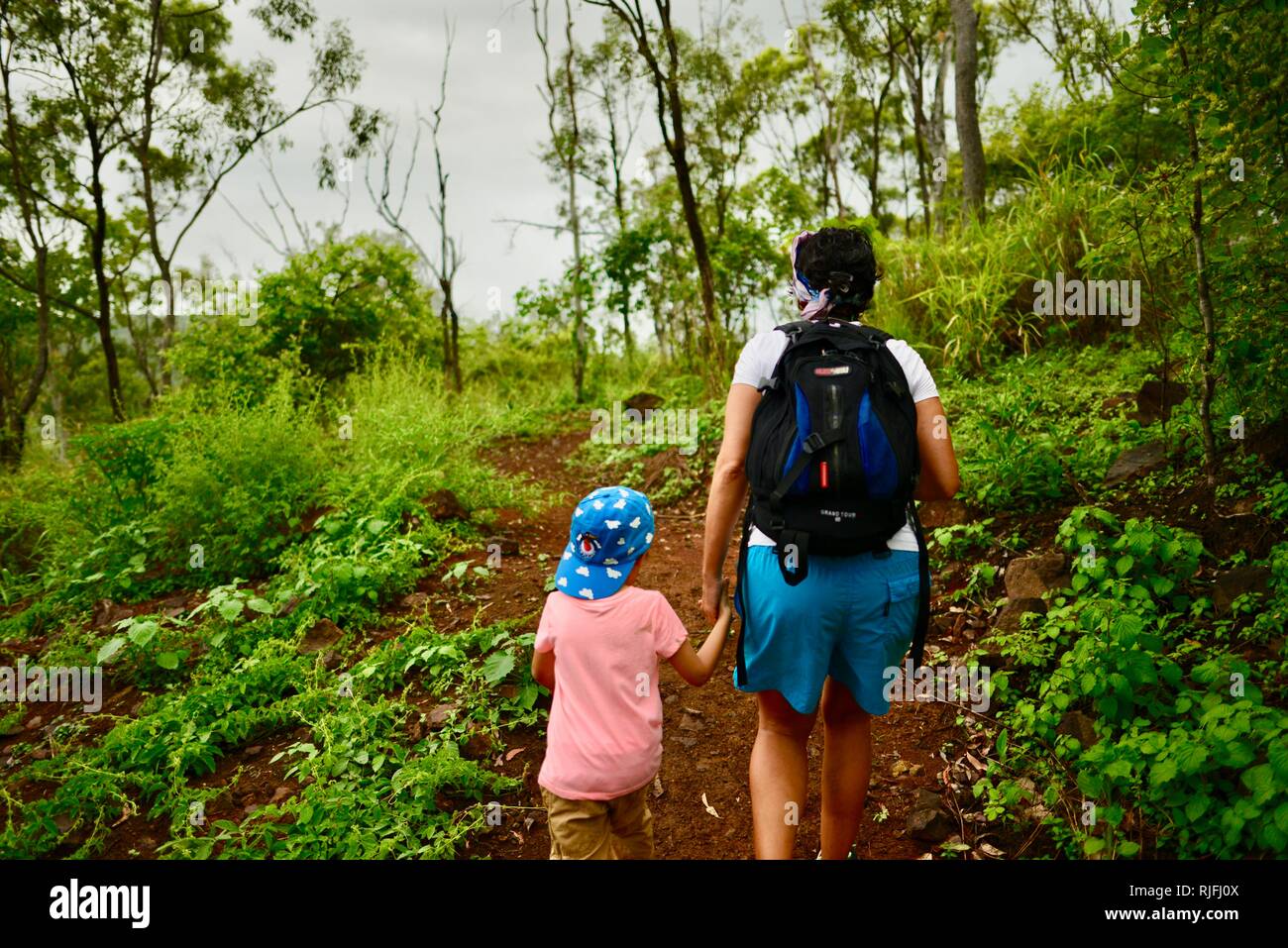 Junge Kinder im Schulalter entlang einem Feldweg, Moongun Wanderweg am Elliot Federn, Townsville, Queensland, Australien Stockfoto