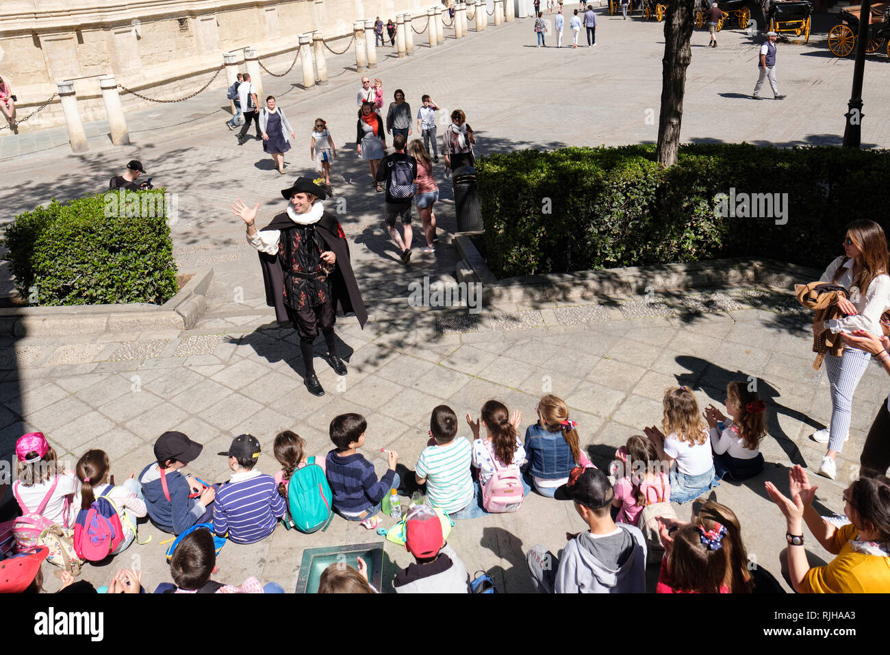 Kinder hören zu einem lokalen Geschichte, Plaza del Triunfo, Sevilla, Spanien, Stockfoto