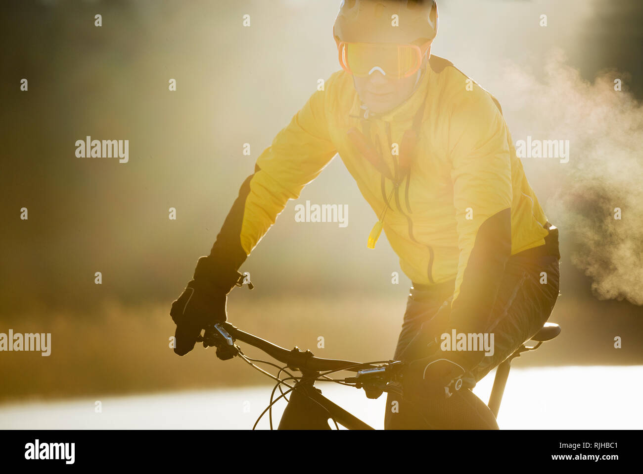 Man Radfahren auf einem zugefrorenen See Stockfoto