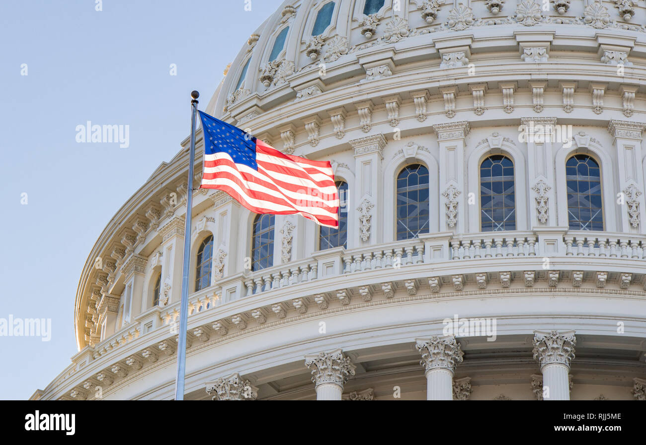 Nahaufnahme der uns Captiol Gebäude Rundbau, in Washington, D.C. mit der amerikanischen Flagge im Wind und einem strahlend blauen Himmel. Stockfoto