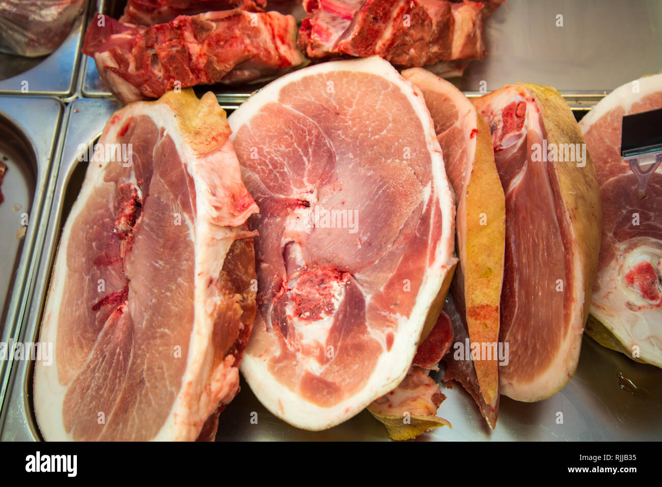 Hervorragende raw saftiges Schweinefleisch aus dem Zähler. Bis zu verlieren. Querschnitt durch ein Stück rohes Schweinefleisch in einem Bio-markt. Stockfoto