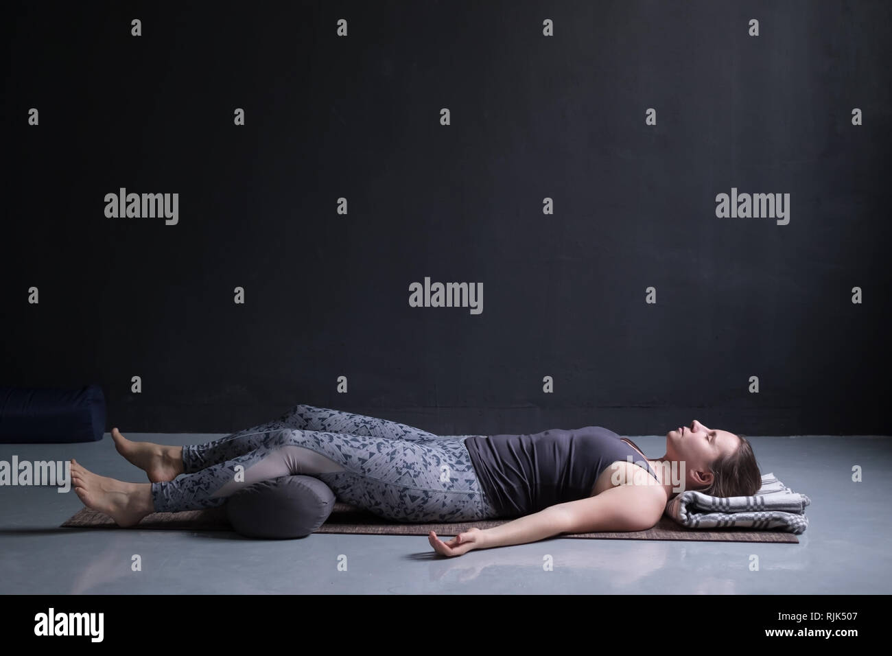 Frau arbeiten, Yoga Übung auf Holzboden, liegen in der Shavasana Stockfoto