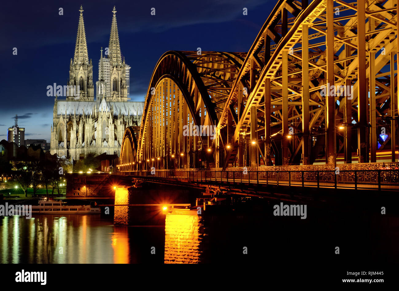 Hohenzollernbrücke und Dom in der Dämmerung, Köln, Deutschland beleuchtet. Schöne romantische Stadtbild Szene. Stockfoto