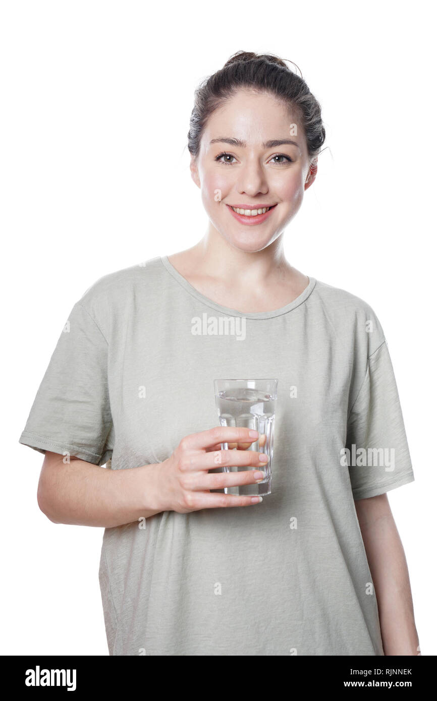 Fröhliche junge Frau hält Glas Wasser Stockfoto
