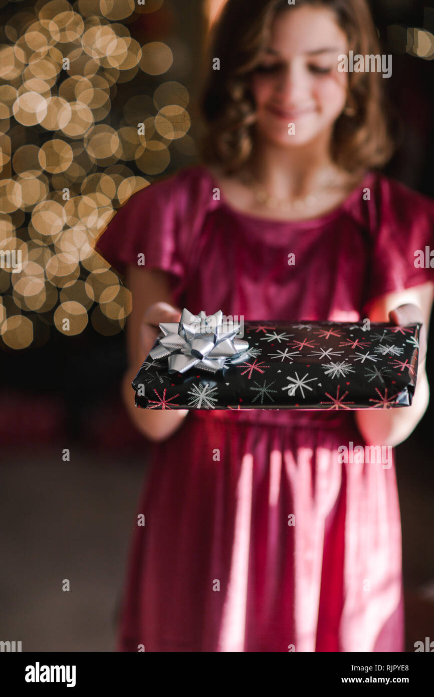 Mädchen hält Weihnachtsgeschenk Stockfoto