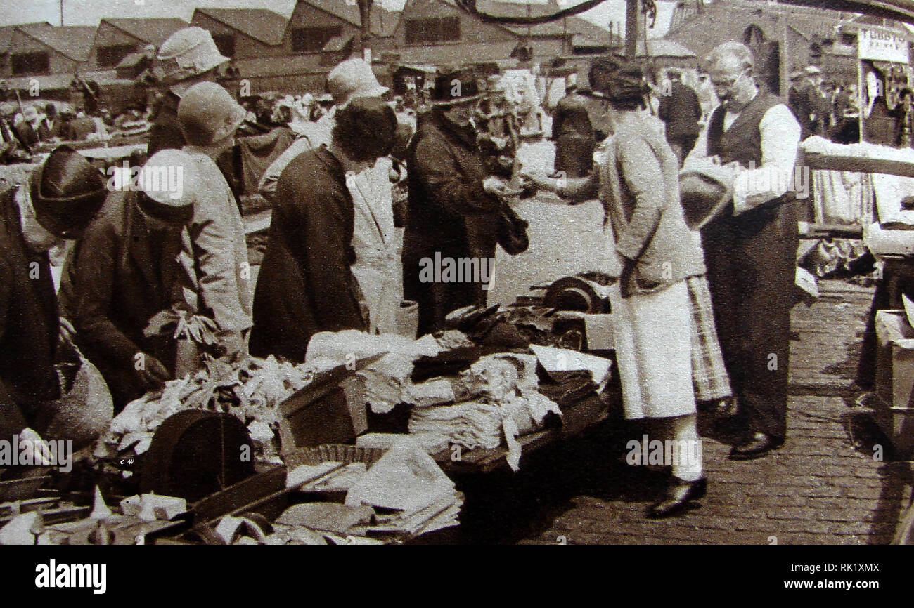 Eine Szene an der alten Caledonian Markt, (die "Cally") Caledonia Road, Islington, London in den 1930er Jahren (es wieder geöffnet nach WK 2 in Bermondsey. Durch das Gesetz waren gestohlen könnte Legal den Besitzer wechseln, wegen einer mittelalterlichen Recht als Markt offene oder Marché ouvert, die ein Käufer das rechtliche Eigentum gewährleistet, wenn ein Element in gutem Glauben an den Markt zwischen Sonnenaufgang und Sonnenuntergang gekauft wurde bekannt Stockfoto